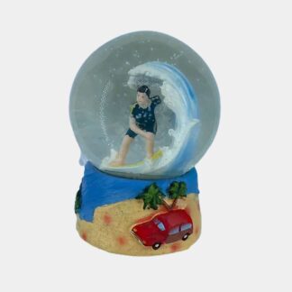 Boule à neige avec surfeur, plage et voiture.